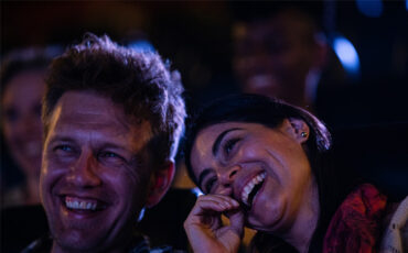 Couple laughing at the theatre